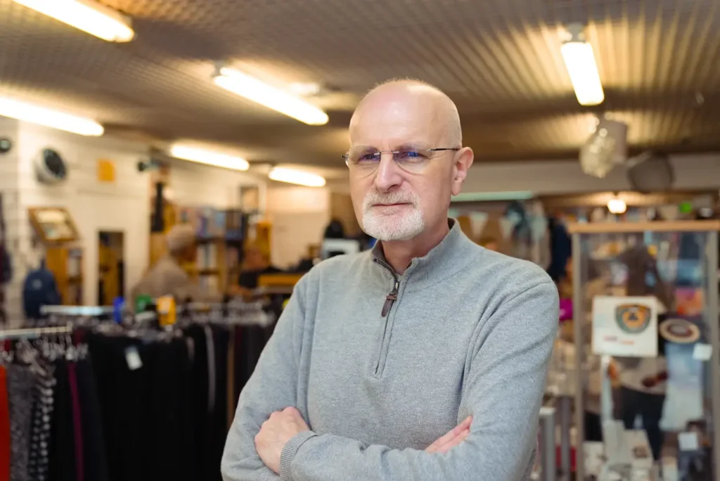 A shop owner standing in his store